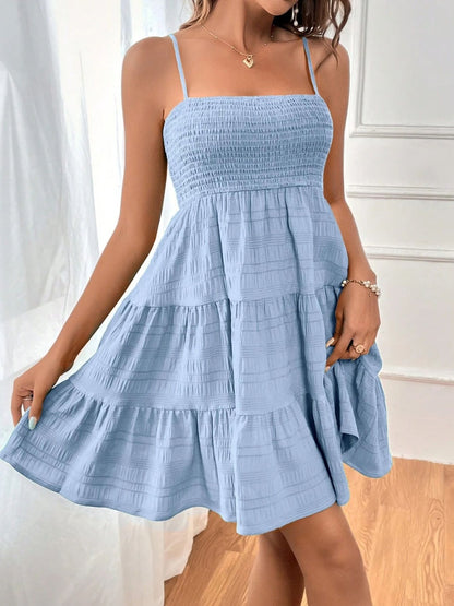 Chic light blue summer dress with tiered ruffles and a smocked bodice, perfect for a breezy, stylish look. Accessorize with dainty jewelry for a feminine touch. Ideal for sunny days and casual outings. #SummerFashion #BlueDress #RuffleDress #CasualChic