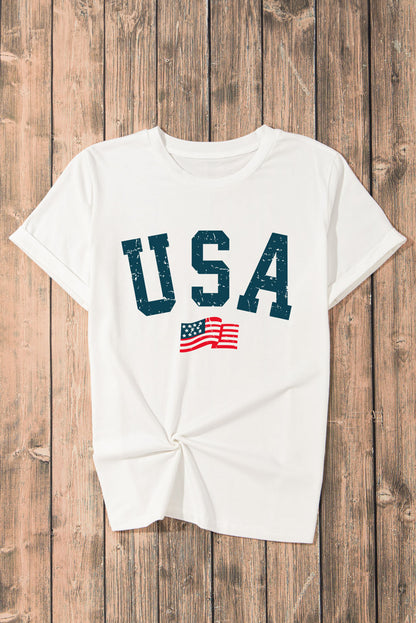 White patriotic USA T-shirt with American flag, displayed on a wooden background. Ideal for national holidays and casual wear.