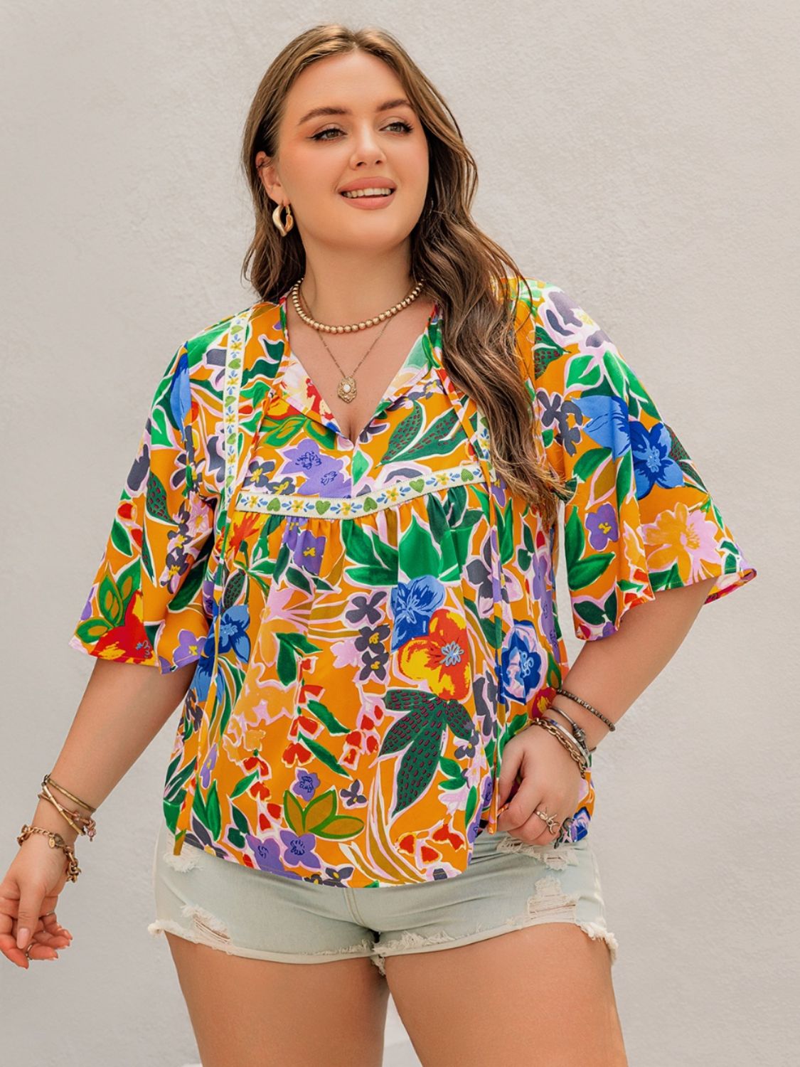 Plus Size Printed Tie Neck Half Sleeve Blouse