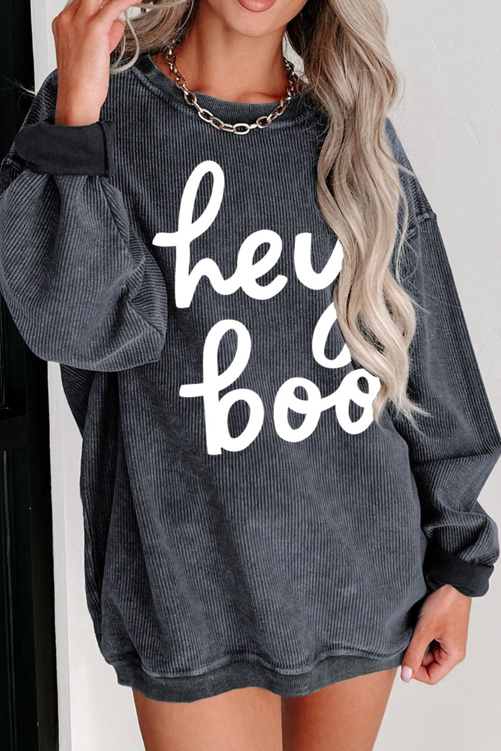 Stylish oversized charcoal sweatshirt with "hey boo" text, perfect for casual fall fashion or a trendy Halloween outfit. Comfort meets style in this must-have pullover.