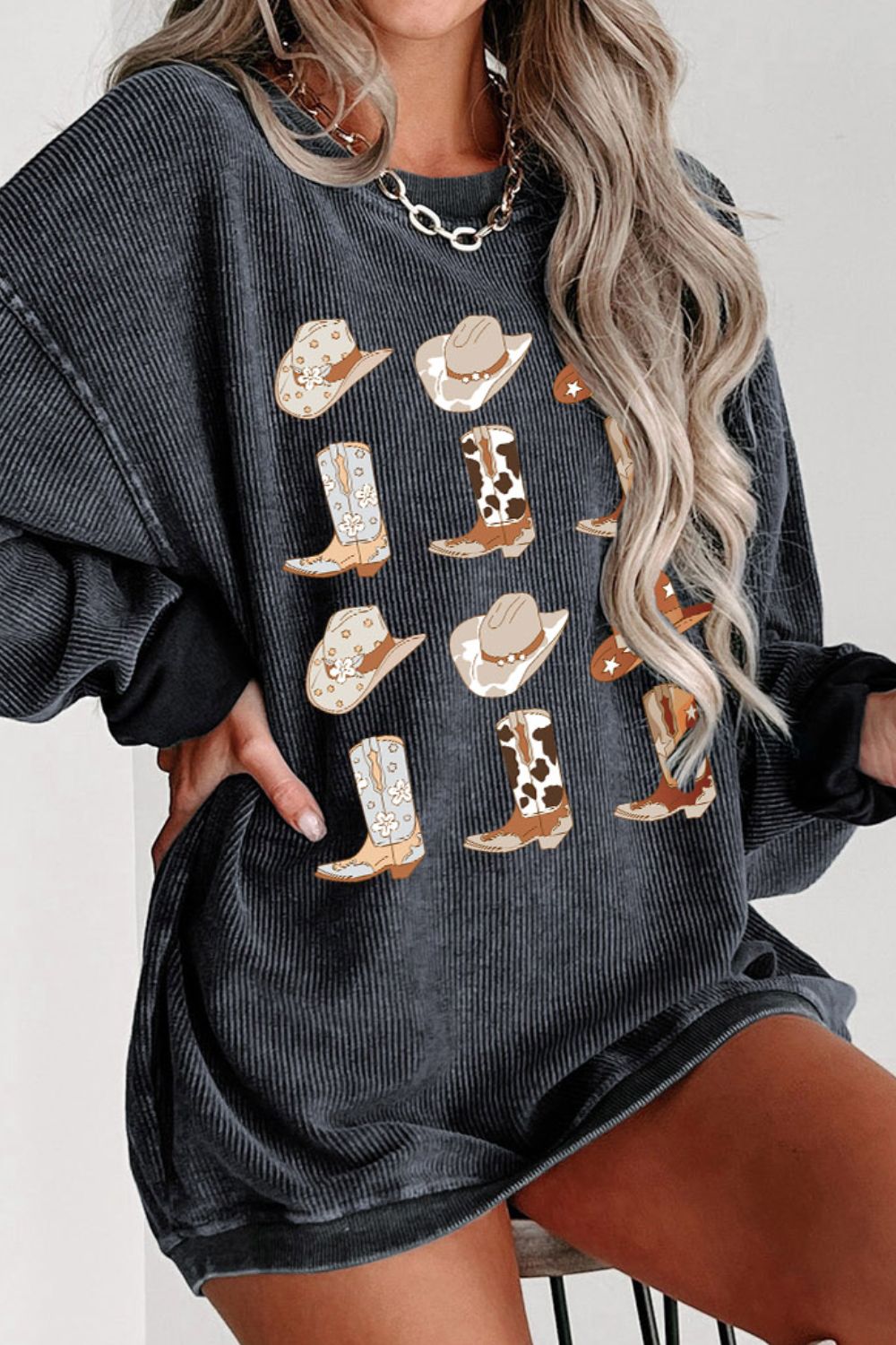 Chic oversized gray sweatshirt featuring playful cowboy boot and hat patterns, perfect for a casual, western-inspired look. Ideal for trendy, comfortable fashion statements. #WesternChic #CasualStyle #OversizedSweatshirt #FashionTrends