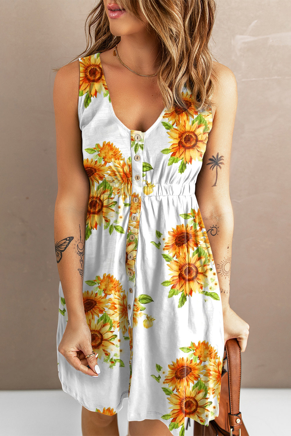 Summer sleeveless dress with a vibrant sunflower print, button details, and a flared skirt for a breezy, chic look. Ideal for sunny outings.