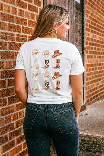 Woman in a white t-shirt with cowboy boots and hats print, posing against a brick wall, highlighting casual western fashion style. #Fashion #WesternStyle #CasualWear